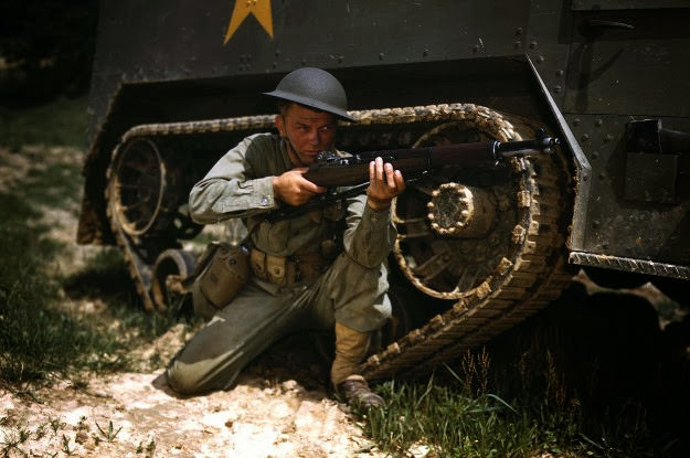 #37 A young armored forces soldier holds a Garand rifle at Fort Knox, Kentucky, 1942.