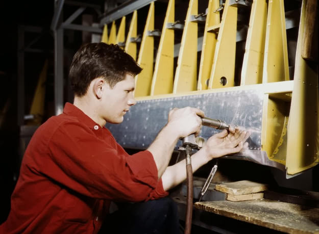 #2 A riveter at work at the Douglas Aircraft Corporation plant in Long Beach, California, 1942.