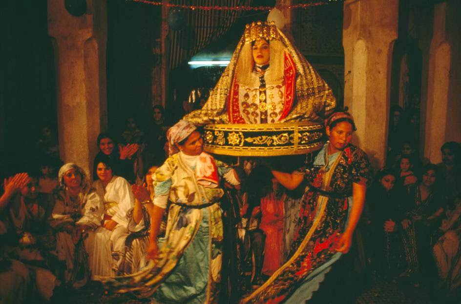 #3 Traditional wedding where arrangers carry the bride wearing a gold dress, 1984.