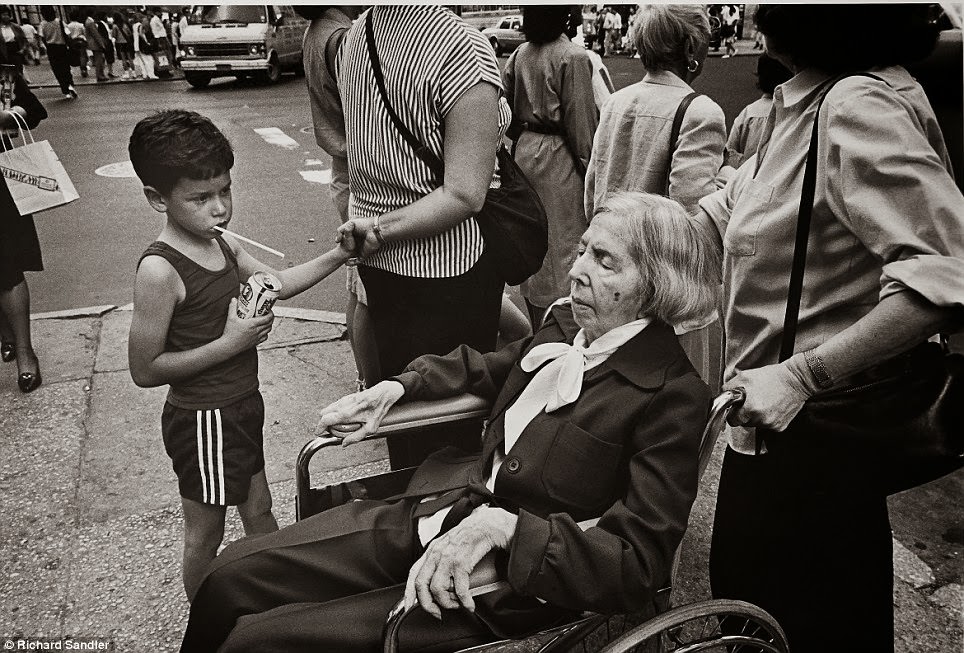 #30 A little boy stares at an elderly woman on Fifth Avenue.