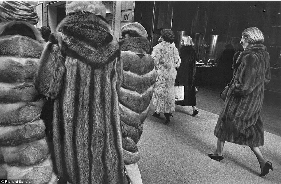 #34 Women stalk Manhattan’s Fifth Avenue clad in expensive fur coats, 1987.