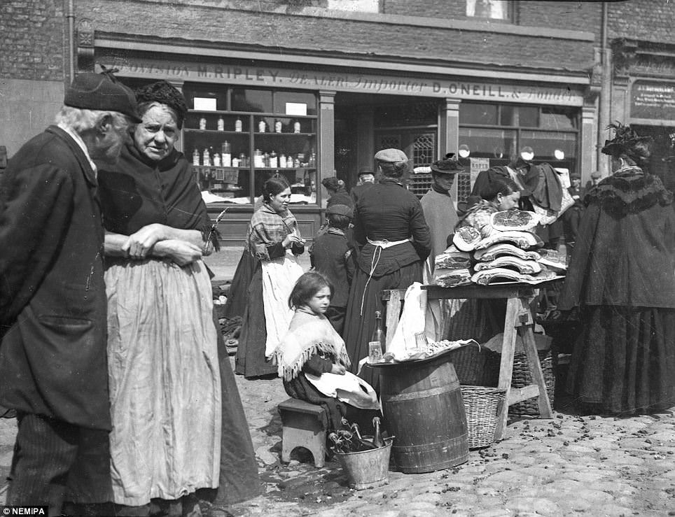 #1 A little girl selling cordial with meat sellers at either Paddy’s Market or Bigg Market, Newcastle.