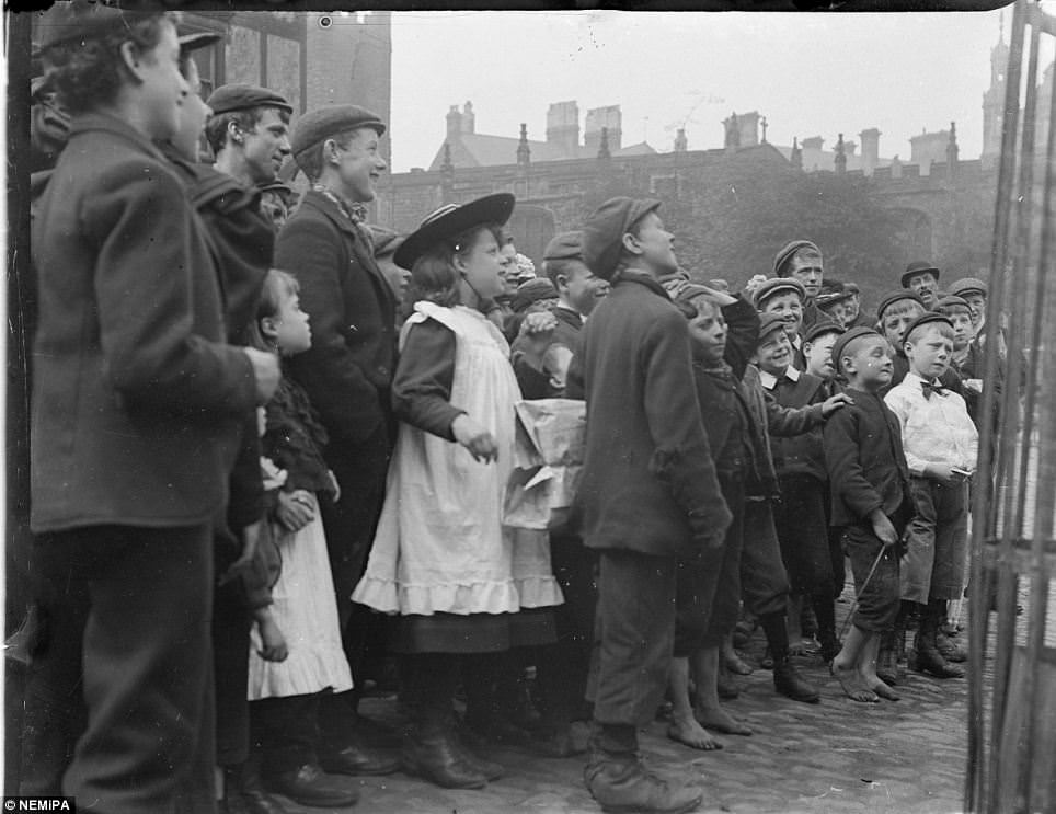 #3 Children gathered outside of the station hotel, Neville street watching a performance.