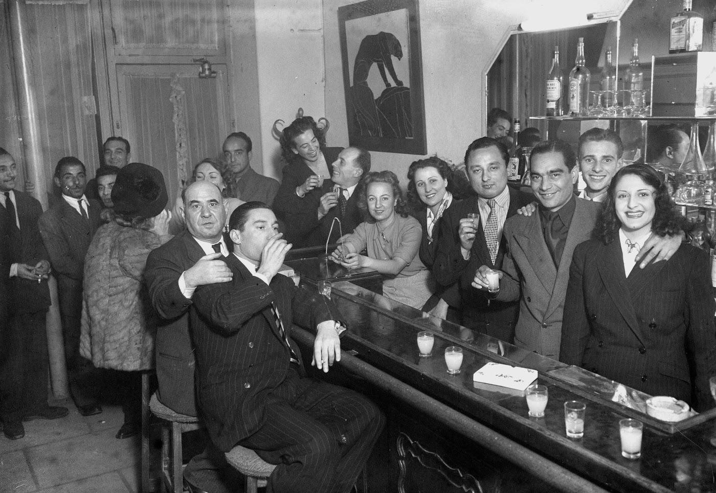 #15 Al Capone with a gang at a bar, 1945.