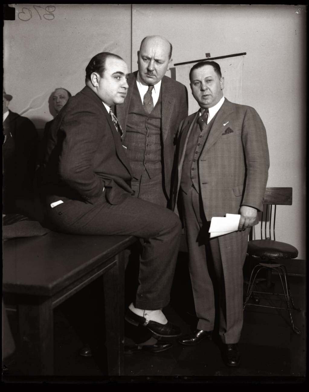 #17 Al Capone, Asst. State Attorney Frank Mast, and Bailiff Joe Weinberg in a Chicago Federal Building courtroom, April 4, 1931.