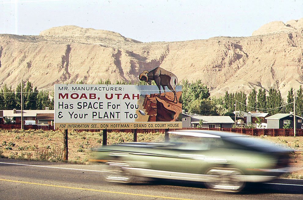 #13 A sign outside Moab, Utah, invites industrial expansion to the region rich in oil, uranium, and potash, 1972.