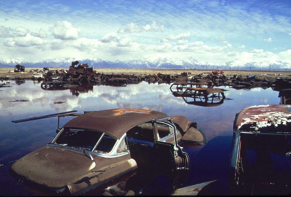 #16 Abandoned automobiles and other debris clutter an acid water and oil-filled five acre pond near Ogden, Utah, which was cleaned up under EPA supervision, 1974.