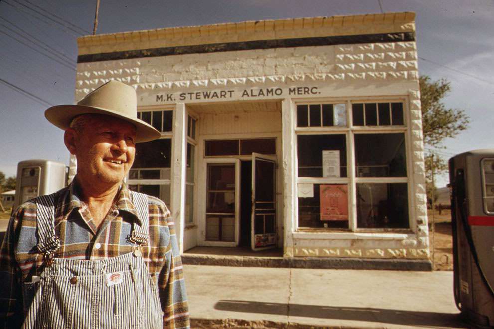 #20 M.K. Stewart, owner of this general store in Alamo, Nevada, wears a TLD (thermo-luminescent dosimeter) to measure radioactive fallout from past atomic testing, 1972.