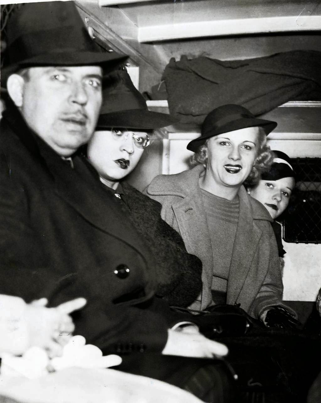 #12 An arrested man and three women sit in the back of a police wagon following a vice raid on the Rialto Theatre on Oct. 17, 1937. Twenty-two women and 10 men were arrested in the surprise raid at the theater and charged with presenting or participating in indecent exhibitions. All arrested were released on $125 bail. In total 70 men and 45 women were arrested in the surprise raids across the city.