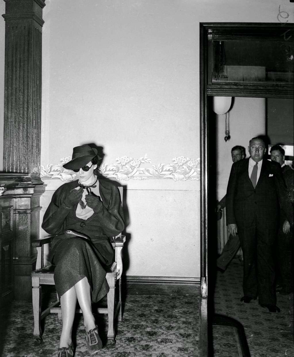 #13 Mrs. Frances Birch, 32-year-old widow of Rock Island, as she appeared on the witness stand in Oregon, Ill. on Oct. 19, 1936, at the murder trial for Guy M. Tallmadge. Tallmadge, who was described by the newspaper as “bald-headed and paunchy” was an assistant undertaker in Rockford who shot and killed his wife Bessie, 51, along a gravel road six miles east of Oregon, Ill. on May 19, 1936. It was Bessie’s birthday. Tallmadge, who had been dating Birch on the side, had given the young widow an engagement ring and said he had asked his wife for a divorce. “I don’t know why he would do anything like that,” Birch said in reference to the murder according to newspaper reports. Later she was ordered to remove her dark sunglasses, which she had worn since the beginning of the trial.