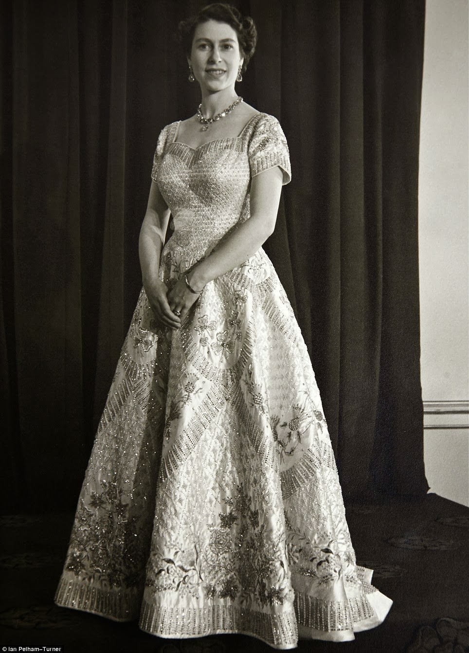 #4 The Queen in her coronation gown that was designed by Sir Norman Hartnell.