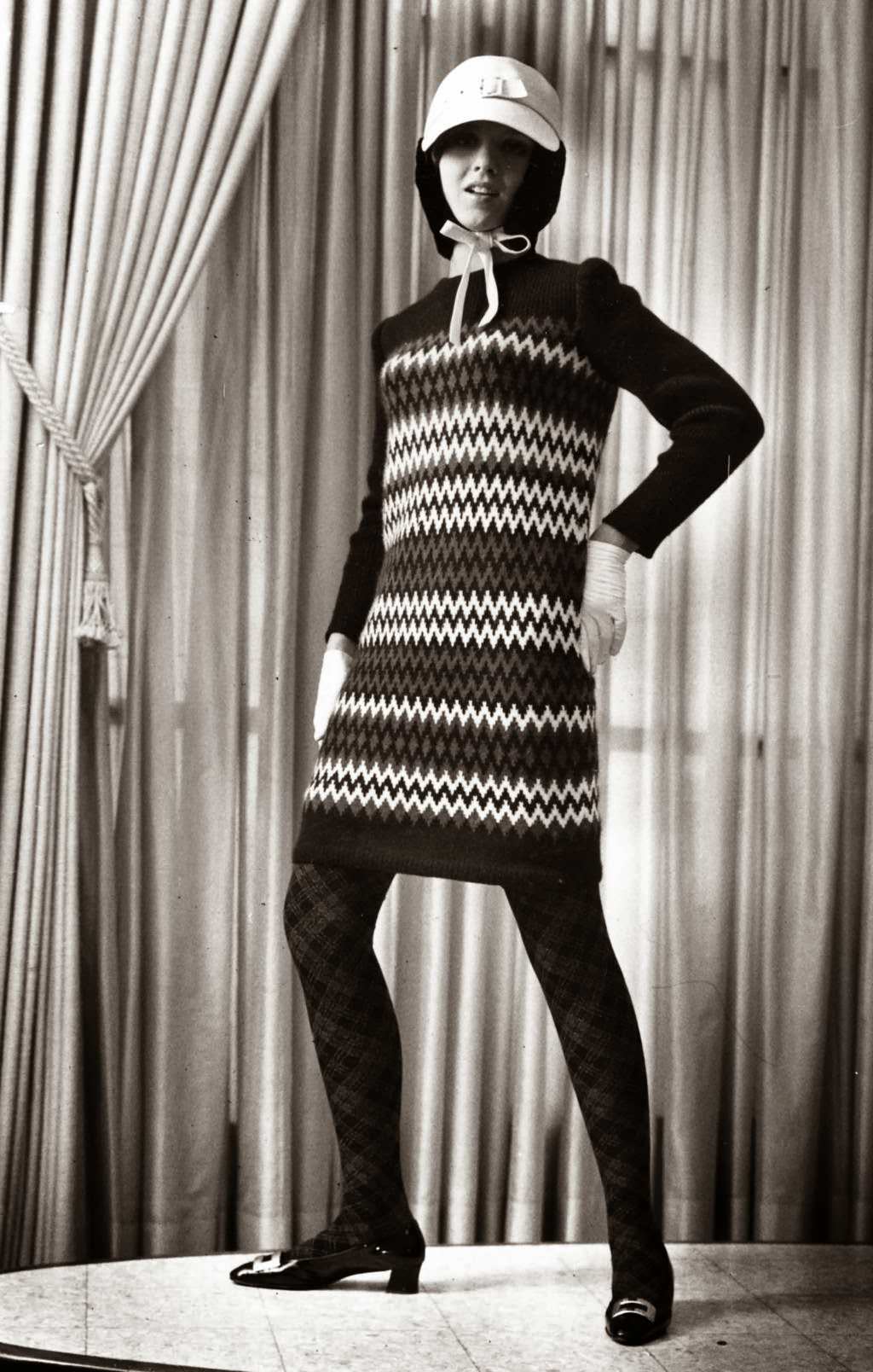 “Bolder than ever conception of a total look comes from Yves St. Laurent, youngest member of the Paris couture. He’s extended the red, white and blue chromatic scheme in this sweater dress with zigzags of the three colors. Argyle wool stockings combine muted blue and red; white leather cap with attached snood of black beaver has brass buckle, as do patent leather, chunky-heeled shoes. Model is Carol Robins of Aquinas Dominican High school.” — Tribune archive photo, Sept. 10, 1966