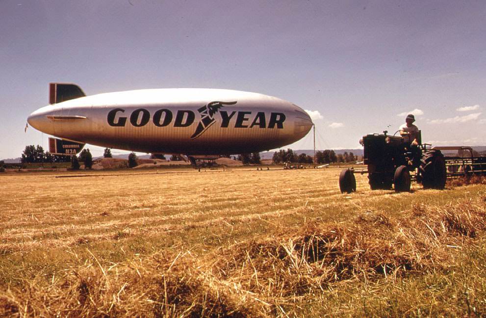 #6 Threshing at Pearson Field, Vancouver, Washington, with the Goodyear Blimp in the background, 1973.