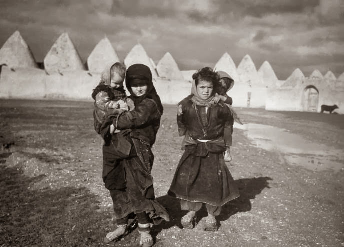 #18 Syrian children outside the walled town of Tell Bisse, Syria, 1940.