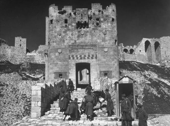 #7 Soldiers urge a mule up the steps of the citadel at Aleppo, Syria, 1940.