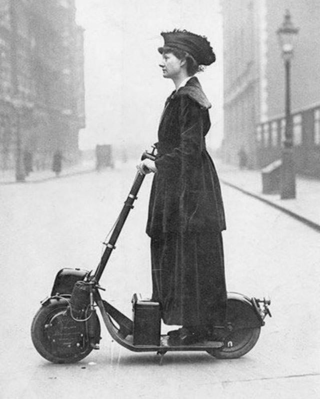 Woman riding a very early electric scooter, 1916.