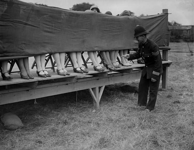 Police officer judging an ankle competition in London, 1930.