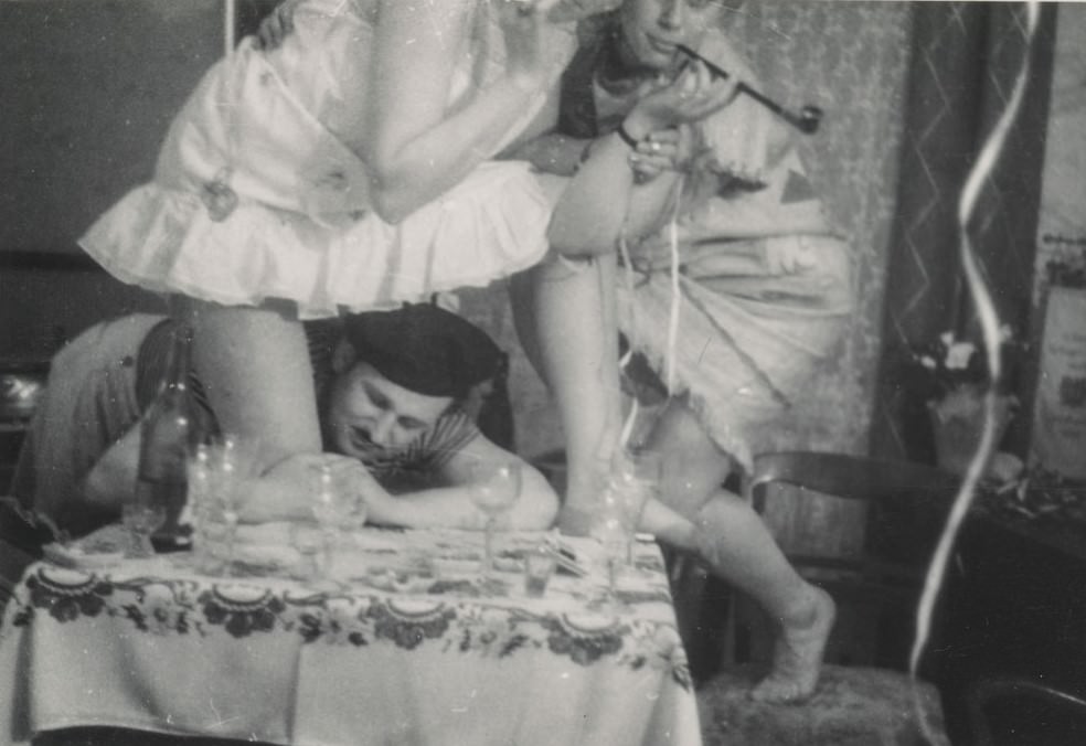 Man grabbing a woman’s leg at a party.
