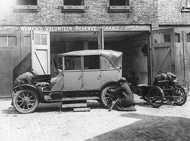 A woman mechanic repairing a car at a Women’s Volunteer Reserve garage.