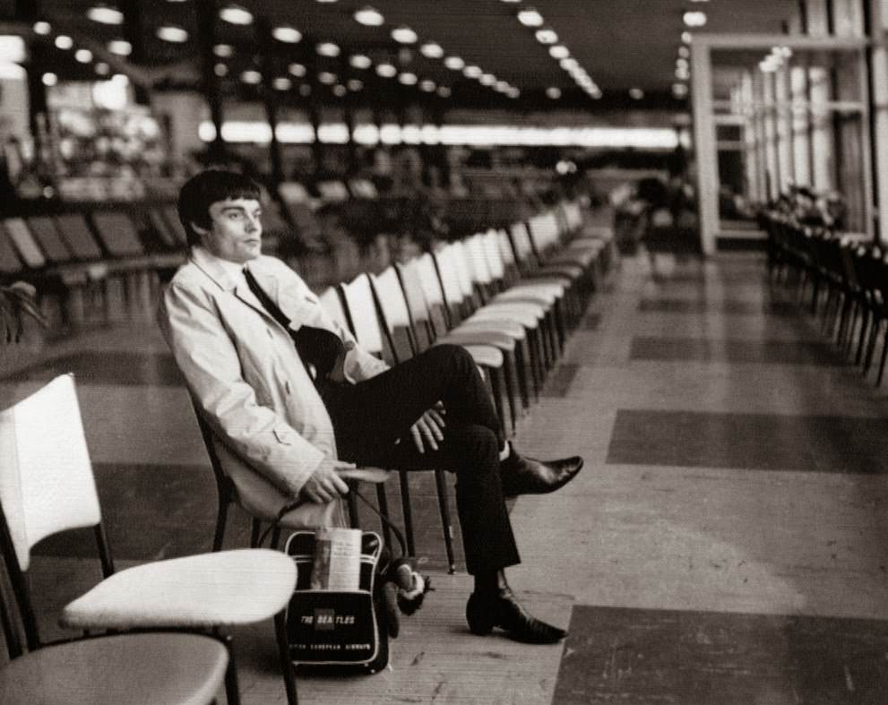 Drummer Jimmy Nicol, who had been stand-in for tonsillitis-stricken Beatle Ringo Starr, sits alone and contemplative at Melbourne’s Essendon Airport, while waiting to return home; Ringo rejoined the Beatles the day before, 1964.