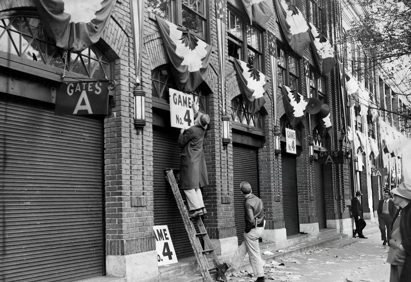 #33 Men put up signs for Game Four of the World Series outside Fenway Park in Boston, 1946.