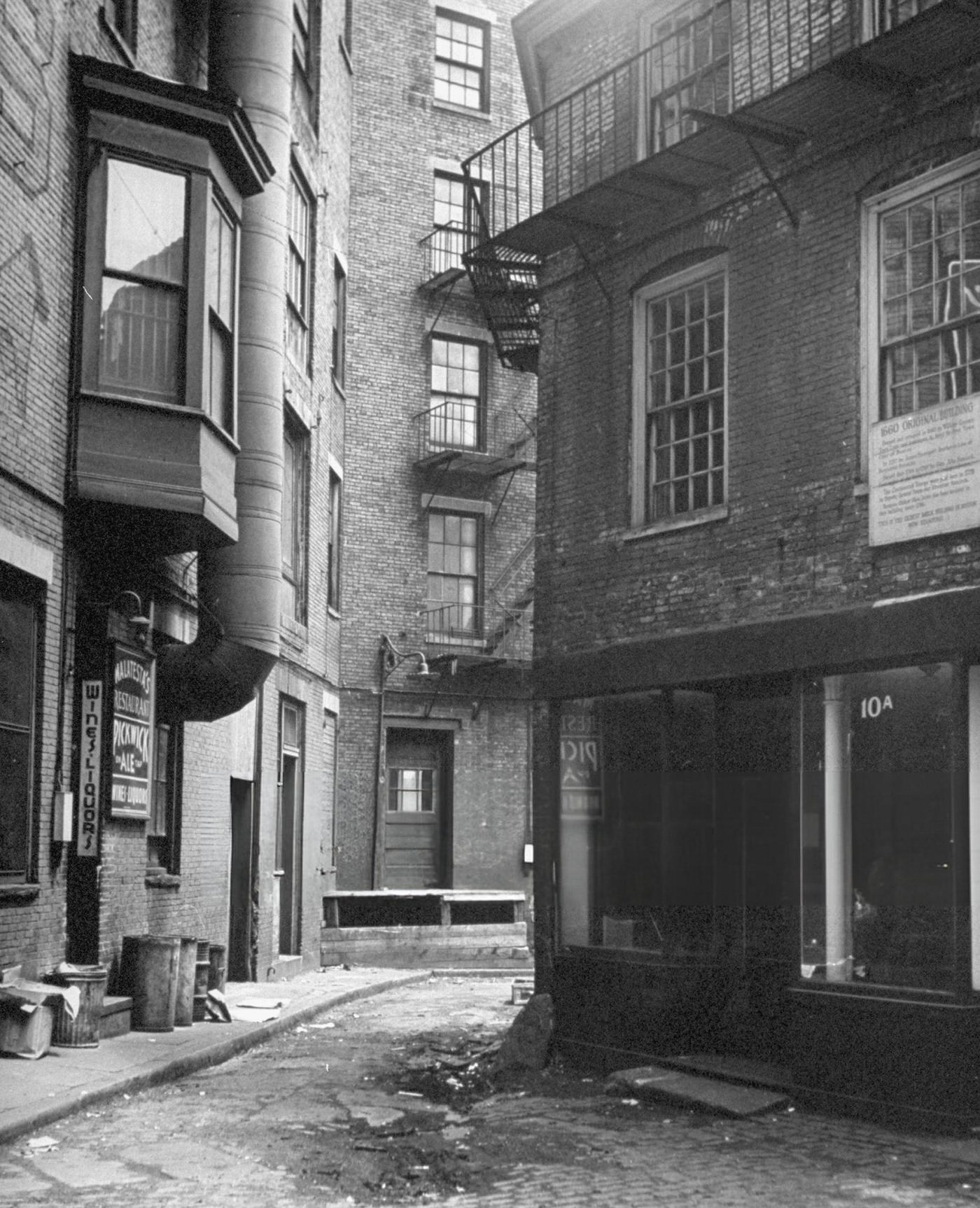 #37 Public 102 Alley, with a sign indicating the city’s oldest brick building still standing, just off Dock Square.