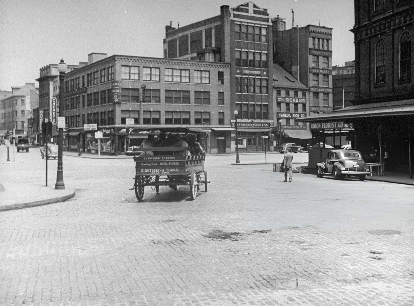 #39 A horse-drawn carriage full of sightseers makes its way through Dock Square.