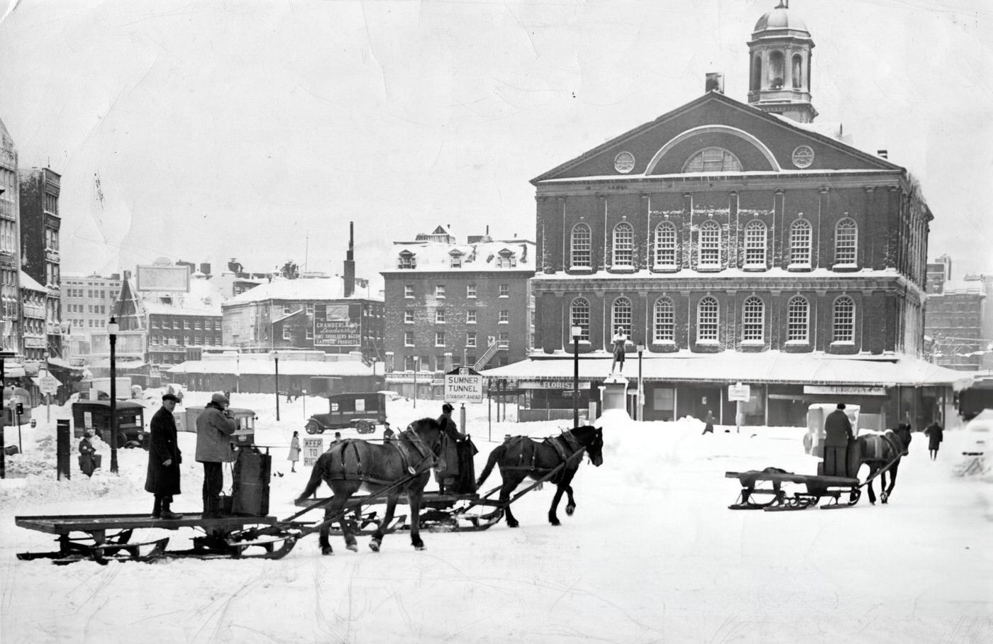 #43 Snow in Boston, 1945. A horse-drawn carriage moves through the snow passed Faneuil Hall after a winter storm, 1945.