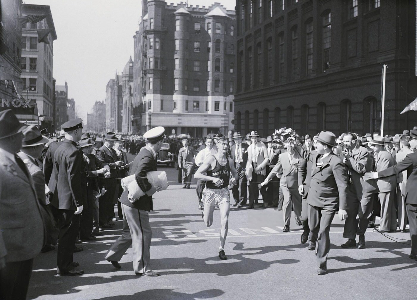 #55 Leslie Pawson crosses the finish line to win the Boston Athletic Association marathon for the third time, 1941.