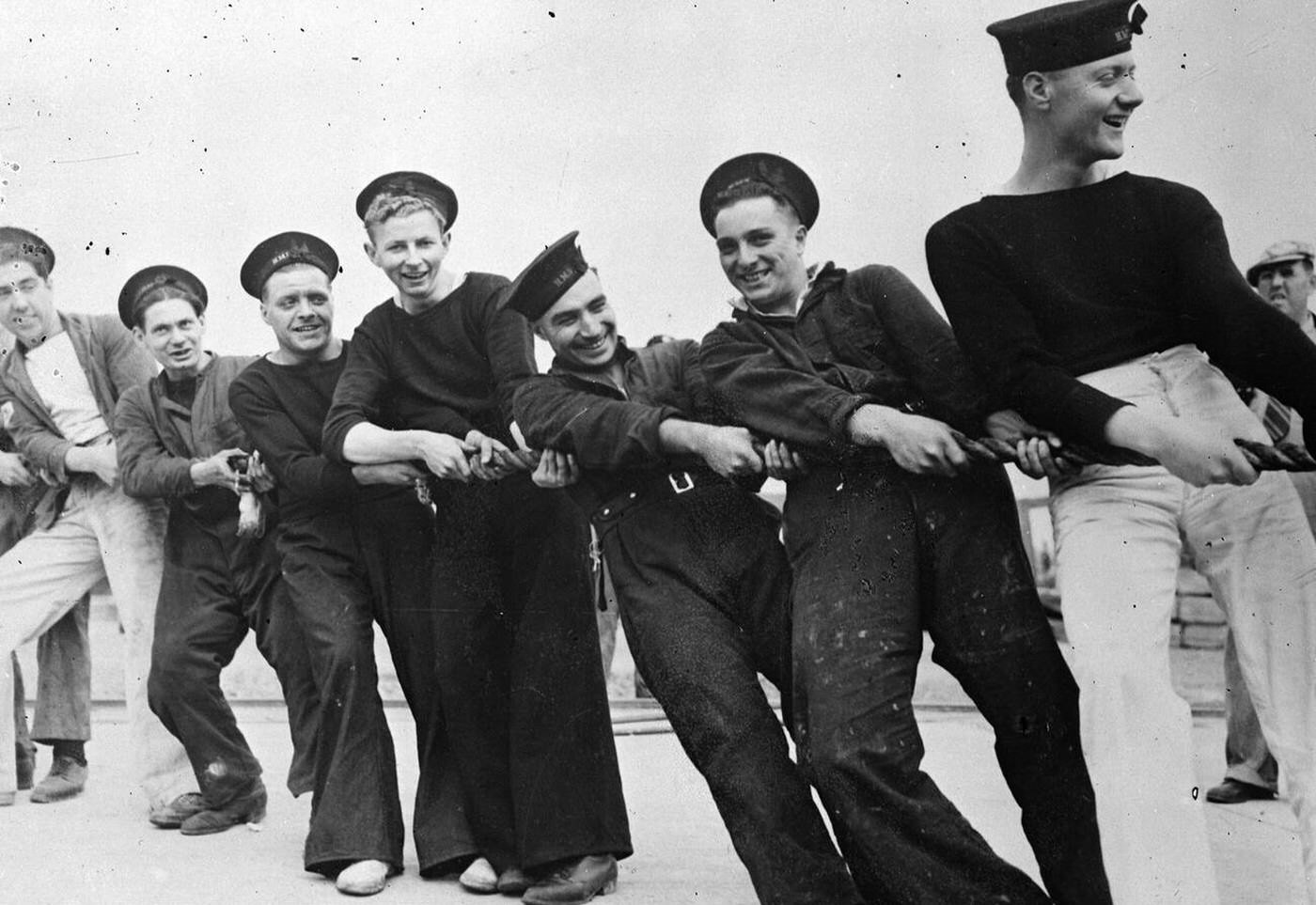 #73 Seaman of the British destroyer Burnham hauling a line as the vessel entered the Boston Navy Yard drydock for repairs, 1941.