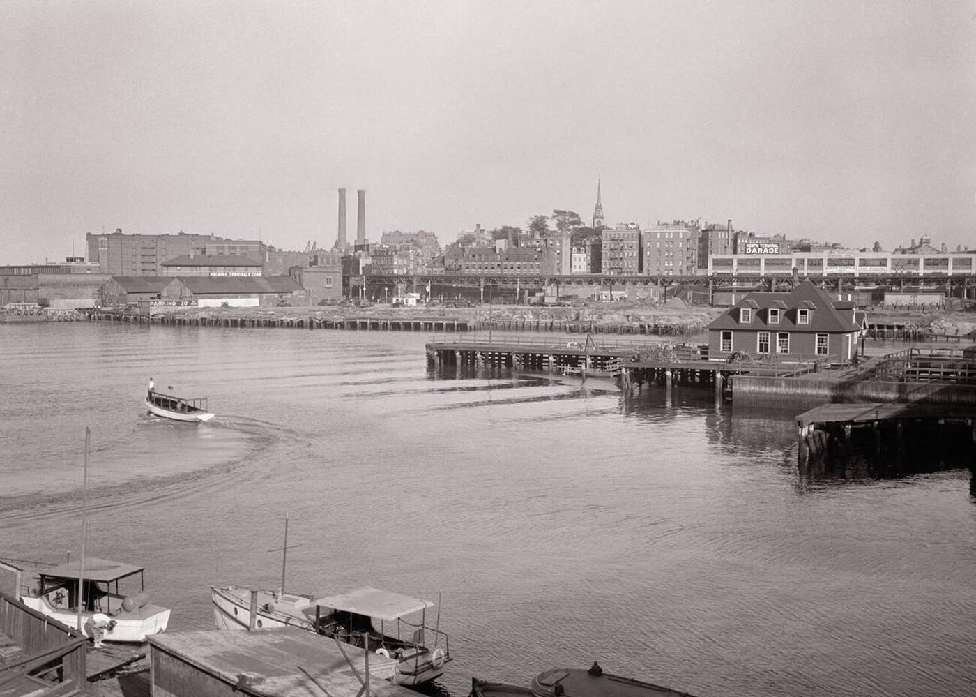 #74 City skyline over the Charles River with the spire of Old North Church visible above newer buildings, Boston, 1940s.