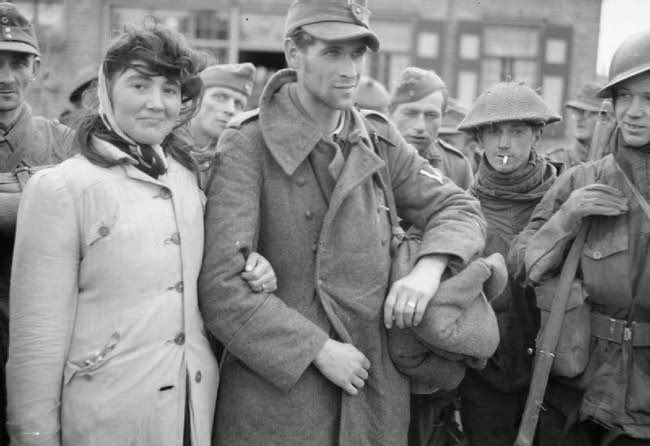 #3 A Dutch woman refuses to leave her husband, a German soldier, after Allied soldiers capture him; she followed him into captivity, 1944.