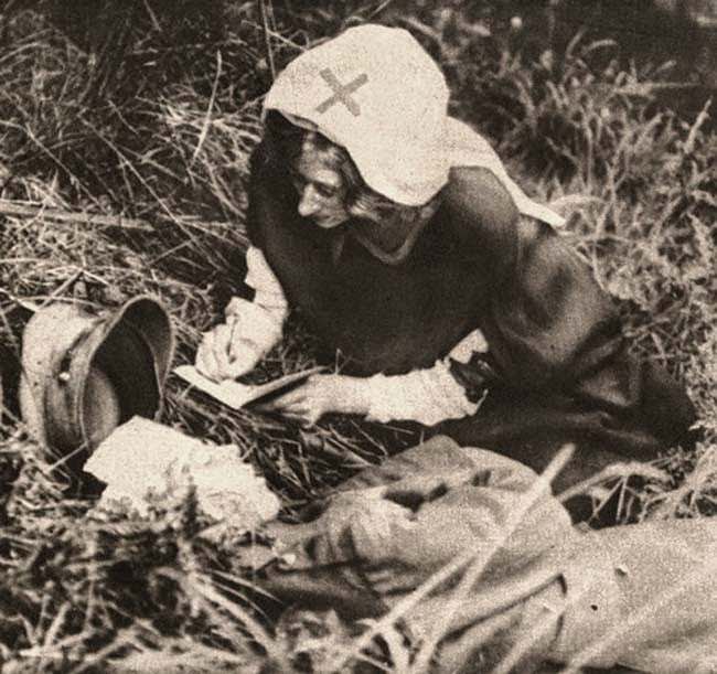 #39 A Red Cross nurse takes down the last words of a British soldier, 1917.