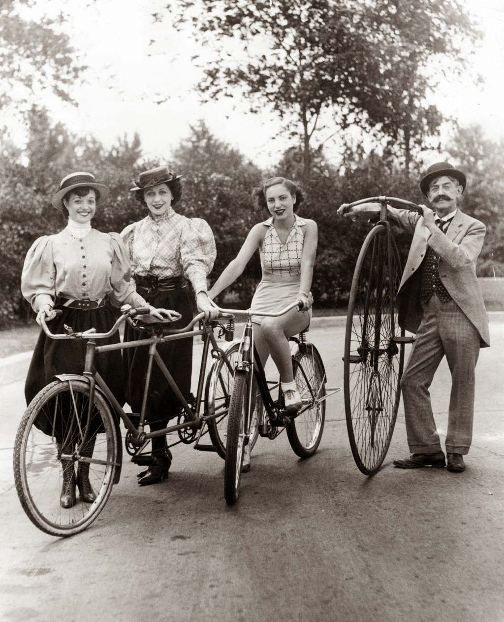 Fannie Ellen, Lillian Dushell, Anita Conier, and Guy Hickman with old-fashioned bikes in Lincoln Park, 1936.
