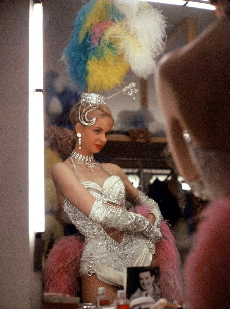 Chorus girl of the Bluebell Girls checking her costume in the dressing room of the Stardust hotel &; casino before a performance, Las Vegas, 1959.