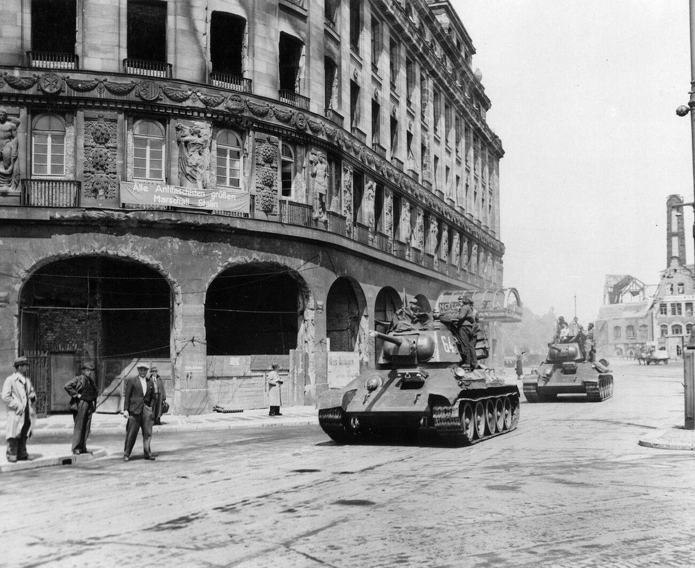 Red Army tanks in Leipzig during the Soviet advance through eastern Germany; the sign on the building reads “All anti-fascists welcome marshal Stalin”.