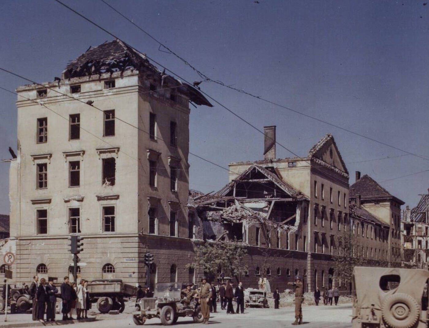 Military Police direct traffic on Zweibrucken Strasse, Main Street of Munich, with rubble from Allied bombing attacks.
