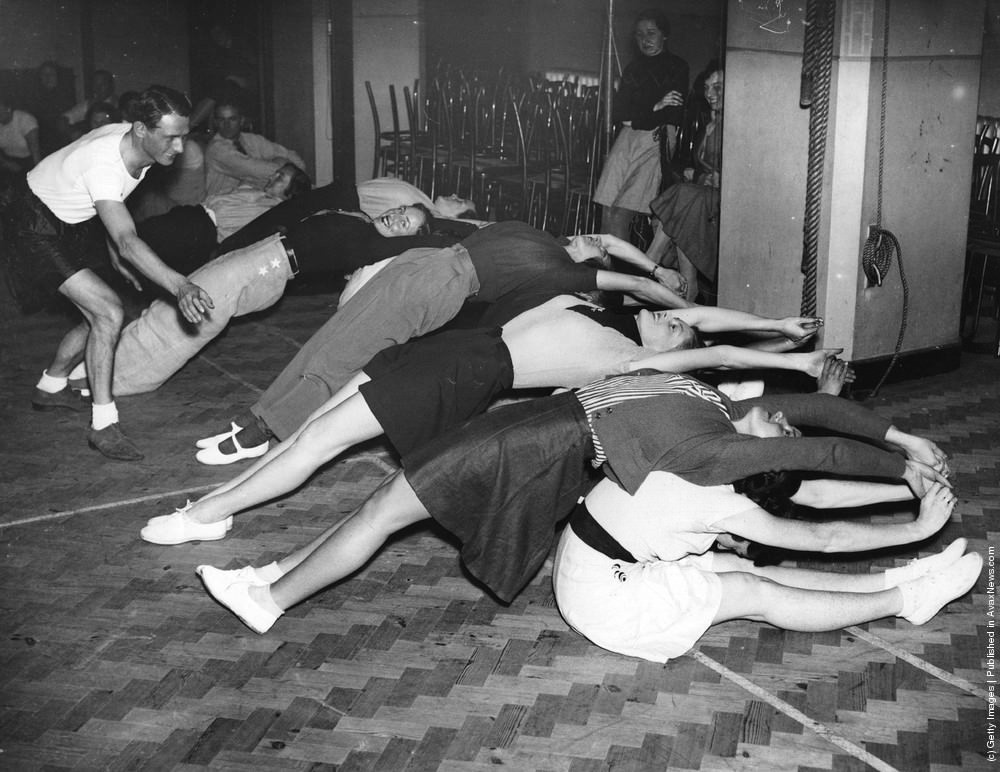 #14 Would-be skiers taking lessons from an Austrian ski champion in the gym, learning that suppleness is essential in skiing, 1936.