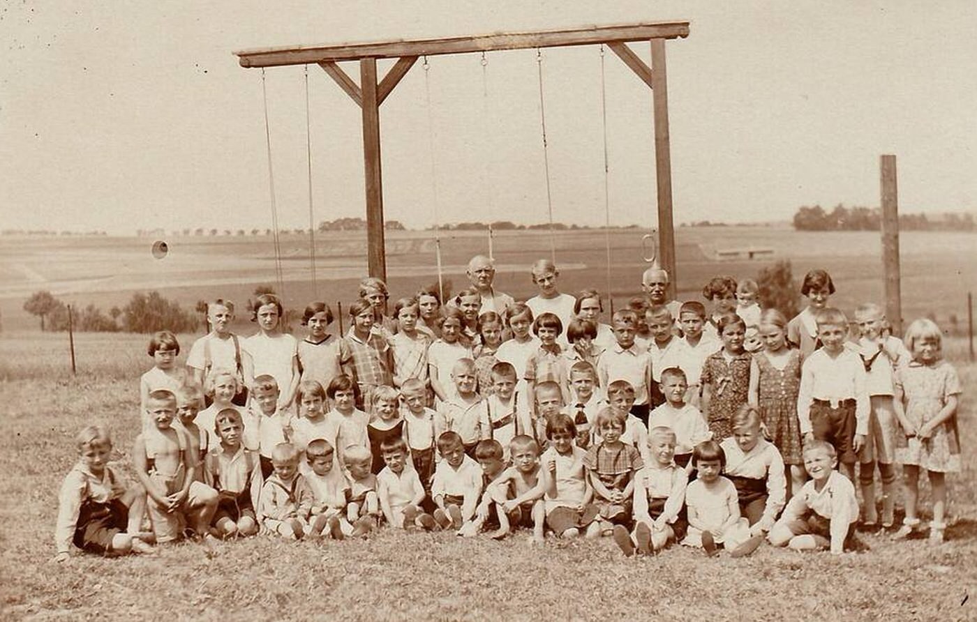 #72 Group of children outdoors with a horizontal bar for rope – climbing on the background, Czechoslovakia, 1930s.