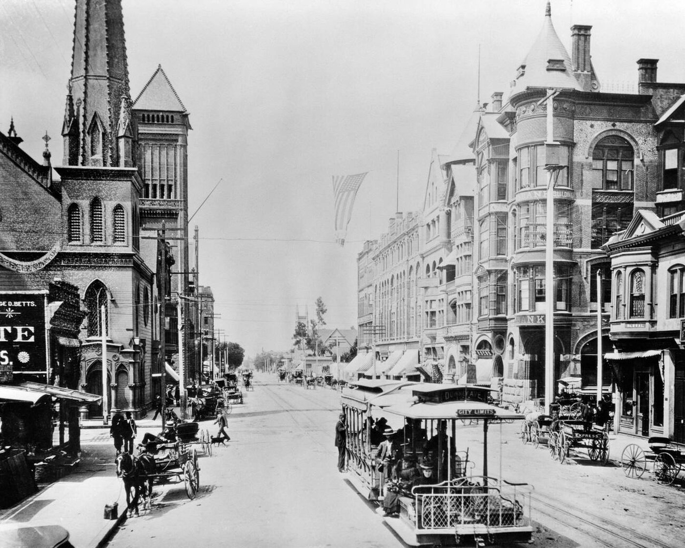 #16 Cable car downtown on Broadway looking south from 2nd Street, with pedestrians, horses and wagons, Los Angeles California, 1880s.