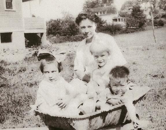 #14 Freda Castle posed with her children, Ruth, Walter and John, in a concrete mixing trough in Long Hill Township, 1928.