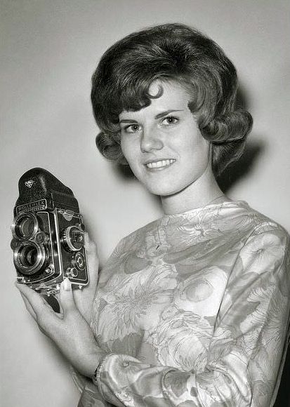 A nice looking 1960’s girl shows off her nice looking Rollieflex.
