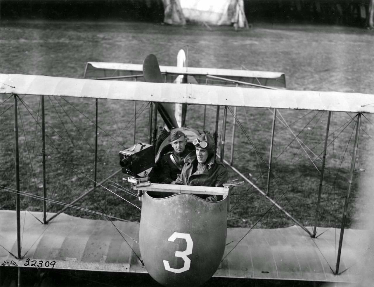 Official Photographer, 2nd Lieut. A.H.C. Sintzenich, S.C. operating Debrie camera from Farman Plane No. 1741 and 1st Lieut. A.W. Bevin, A.S. pilot, about to make a flight over the Aerodrome.
