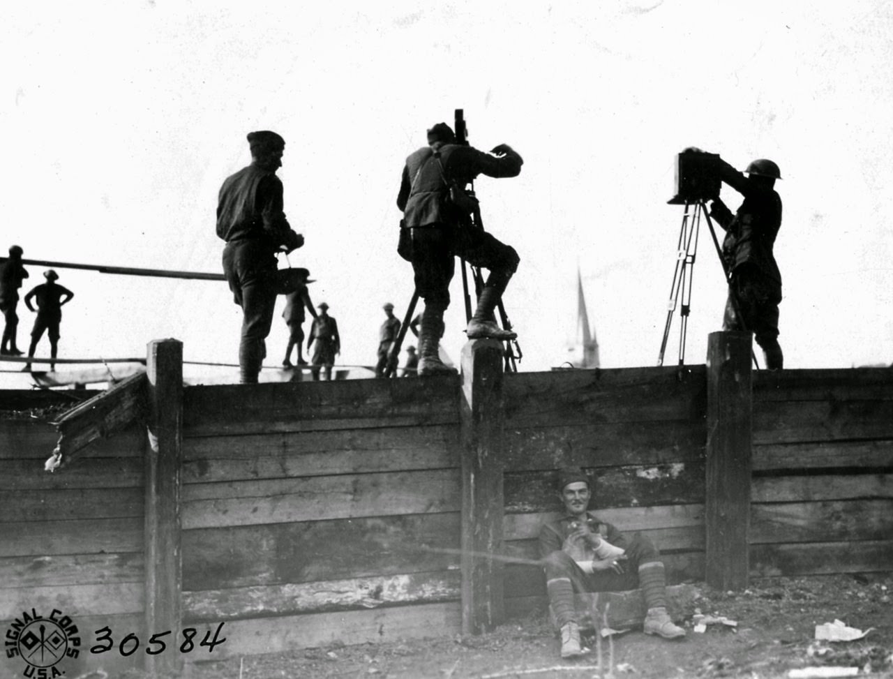 Photo Unit photographing the bridge at Grandpre over the Aire River which had been 3x blown by the Germans, and rebuilt Co. B, 303rd Engrs, Grandpre, Ardennes, F.
