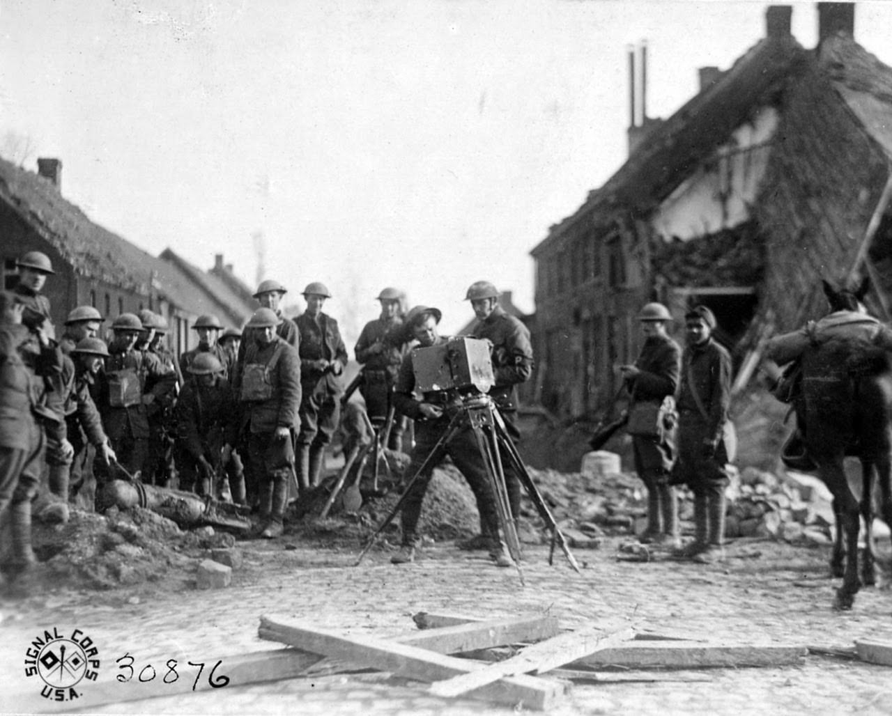 Engineers removing the aerial bomb planted under the bridge which did not explode; S.C. cameraman on the job.