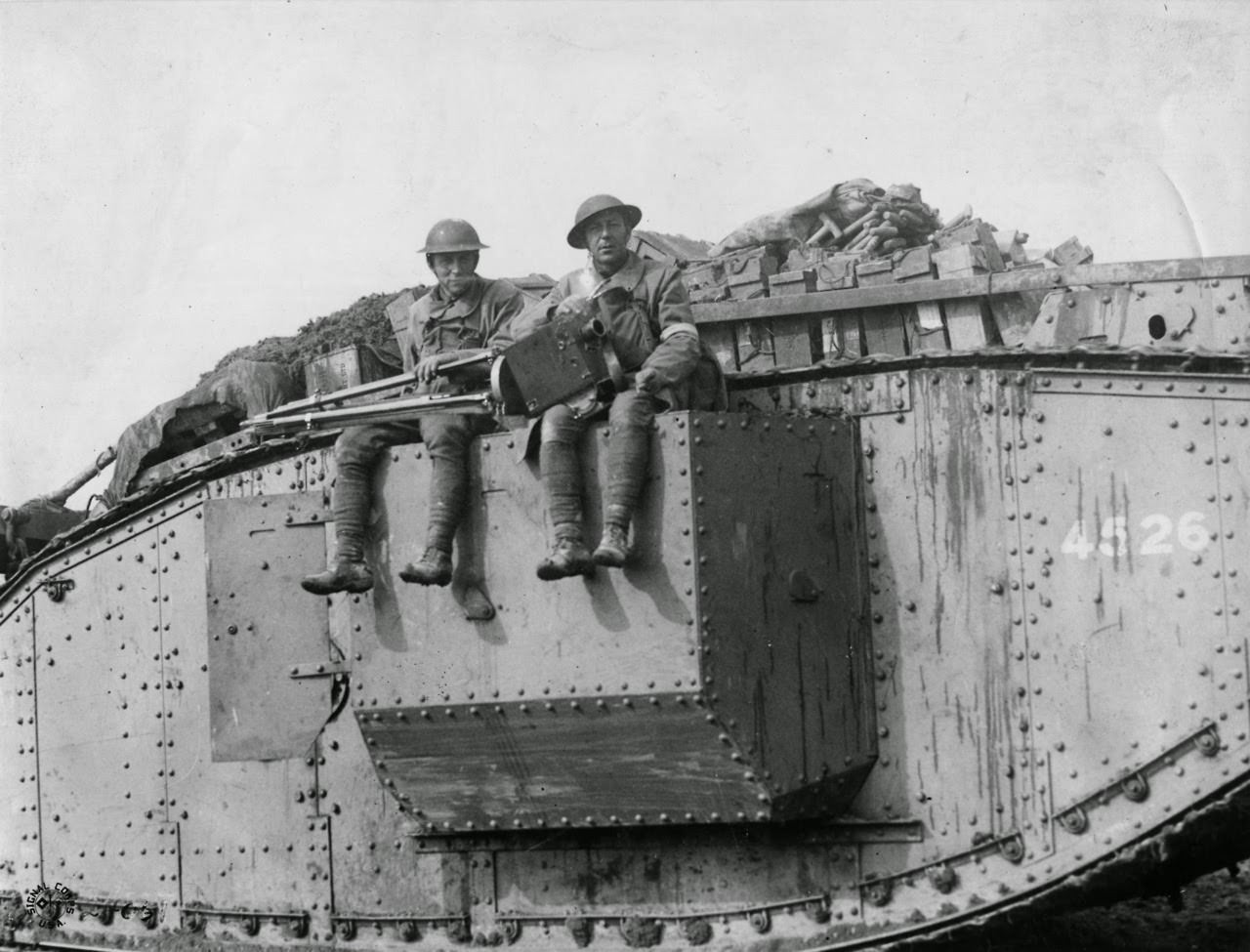 Photographers going into battle on a British Army Tank: Sgt Morris and Pvt Persse, S.C. on battlefield between Villeret and Bellicourt, 1918.