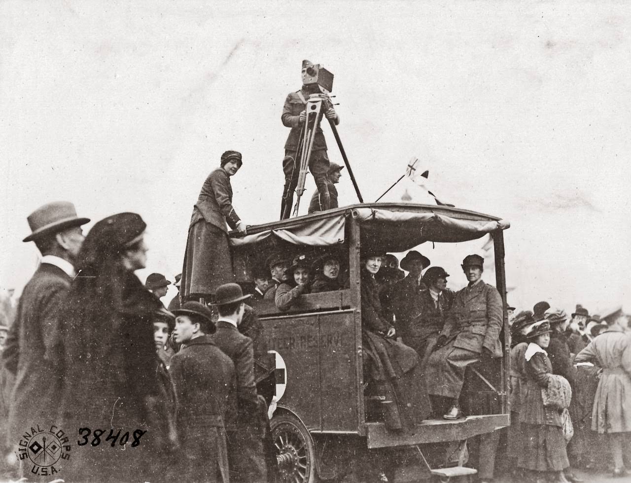 Lt. Sintzenich on roof of ambulance making moving pictures of crowd outside of Buckingham Palace celebrating signing of Armistice.