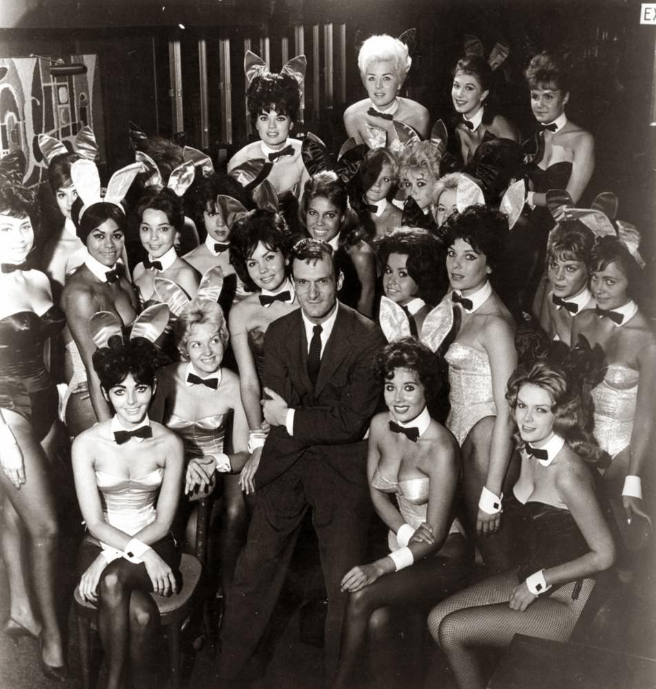 Millionaire publisher of Playboy magazine Hugh Hefner poses with a bevy of bunny girls at one of America’s chain of Playboy clubs.