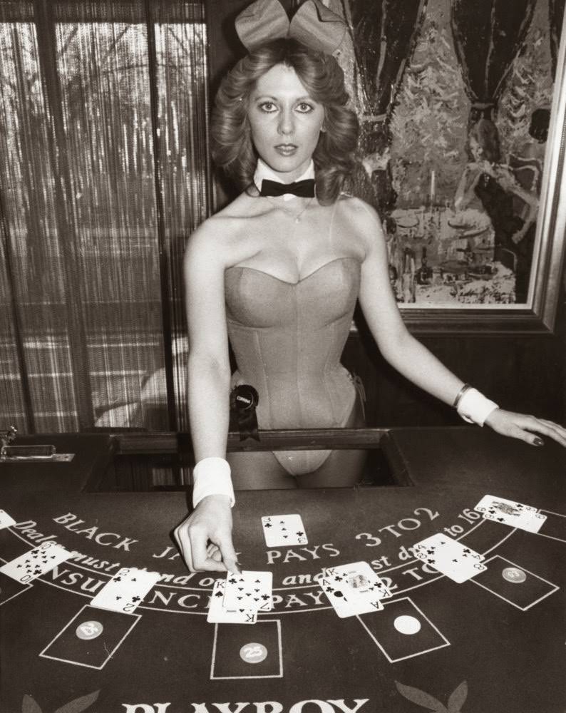Croupier and bunny girl, Corrina, dealing cards at the Hefner-Playboy Park Lane club in London, 1978.