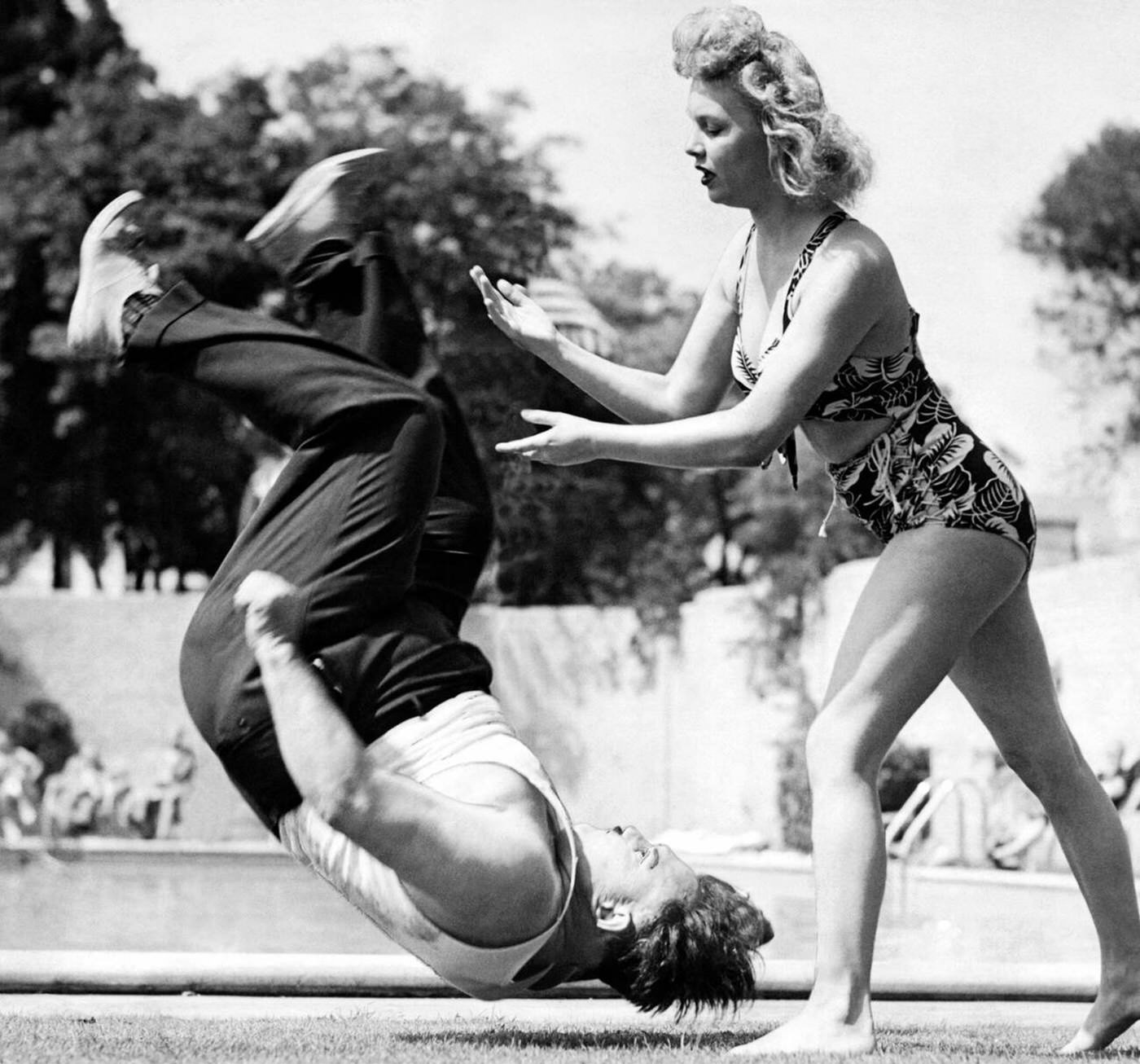 #17 A woman judo instructor demonstrates how to flip a man on an LA high school teacher, Los Angeles, California, 1944.